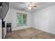 Cozy carpeted bedroom with bright window and neutral walls, offering a peaceful retreat at 134 Waterloch Ct, Lawrenceville, GA 30043