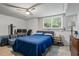 Bedroom with neutral carpet, ceiling fan, and large window at 134 Waterloch Ct, Lawrenceville, GA 30043