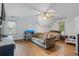 Spacious carpeted bedroom with ceiling fan, TV, and natural light at 134 Waterloch Ct, Lawrenceville, GA 30043