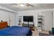 Bedroom with neutral carpet, ceiling fan, and large television at 134 Waterloch Ct, Lawrenceville, GA 30043