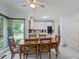 Dining area featuring hardwood table and floors with white cabinets and modern appliances at 134 Waterloch Ct, Lawrenceville, GA 30043