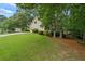 Beautiful home surrounded by lush green trees and well-maintained lawn at 134 Waterloch Ct, Lawrenceville, GA 30043
