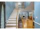 Light-filled foyer with hardwood floors, staircase, and views into the living area at 134 Waterloch Ct, Lawrenceville, GA 30043