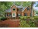 Two-story brick home featuring manicured landscaping and classic black shutters at 134 Waterloch Ct, Lawrenceville, GA 30043