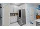 This kitchen features white cabinetry, stainless steel appliances, marbled floors, and a full sized refrigerator at 134 Waterloch Ct, Lawrenceville, GA 30043