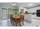A kitchen featuring white cabinetry, marble floors, a breakfast nook and natural light from multiple windows at 134 Waterloch Ct, Lawrenceville, GA 30043