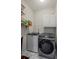 Modern laundry room with updated appliances and shelving for storage of detergents and other laundry supplies at 134 Waterloch Ct, Lawrenceville, GA 30043
