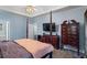 Main bedroom with a four poster bed, large dresser, mini fridge and ceiling fan with lighting at 134 Waterloch Ct, Lawrenceville, GA 30043