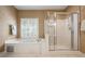 Bathroom with a soaking tub, shower and a window with wooden shutters at 1772 Benningfield Sw Dr, Marietta, GA 30064