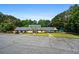 Community clubhouse with well-manicured landscaping, ample parking, and a playground in the background at 1772 Benningfield Sw Dr, Marietta, GA 30064