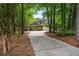 Long driveway leading to a two-story brick home with a spacious garage, surrounded by trees at 1772 Benningfield Sw Dr, Marietta, GA 30064