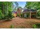 Charming brick home with mature landscaping and dark shutters on a lush, wooded lot at 1772 Benningfield Sw Dr, Marietta, GA 30064