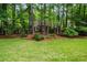 Charming home nestled among lush trees with a well-maintained lawn and landscaping at 1772 Benningfield Sw Dr, Marietta, GA 30064