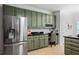 Well-equipped kitchen with stainless steel refrigerator and ample cabinet space for efficient organization and storage at 1772 Benningfield Sw Dr, Marietta, GA 30064