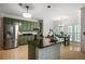 Kitchen featuring stainless steel appliances, black countertops, a functional island, and a seamless flow to the dining area at 1772 Benningfield Sw Dr, Marietta, GA 30064