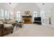 Comfortable living room with vaulted ceilings and ample natural light from large windows and a cozy brick fireplace at 1772 Benningfield Sw Dr, Marietta, GA 30064
