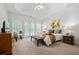 Bright main bedroom featuring a tray ceiling, french doors and a large bed at 1772 Benningfield Sw Dr, Marietta, GA 30064