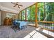 Inviting screened porch with stone flooring, outdoor furniture, and views of the lush backyard at 1772 Benningfield Sw Dr, Marietta, GA 30064