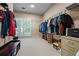 Large walk-in closet with built in shelving for clothes, shoes and accessories at 1772 Benningfield Sw Dr, Marietta, GA 30064