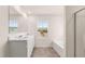 Bathroom with double vanity sinks, large mirror, and bathtub at 1940 Van Allen Ct, Dacula, GA 30019
