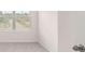 Bedroom with neutral carpet with a view of the neighborhood through the window at 1940 Van Allen Ct, Dacula, GA 30019