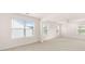 The bonus room is large with neutral paint, carpet floors, and lots of natural light at 1940 Van Allen Ct, Dacula, GA 30019