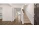 Open entryway with wood flooring, stairway, and views of the kitchen at 1940 Van Allen Ct, Dacula, GA 30019
