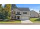 Charming two-story home with brick and siding exterior, well-manicured lawn, and attached two car garage at 1940 Van Allen Ct, Dacula, GA 30019