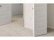 Hallway featuring carpet flooring and white paneled doors at 1940 Van Allen Ct, Dacula, GA 30019