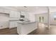 Open-concept kitchen featuring white cabinetry, granite countertops, stainless steel appliances, and hardwood flooring at 1940 Van Allen Ct, Dacula, GA 30019