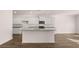 Open-concept kitchen with a large island, white cabinets, granite countertops, and stainless-steel appliances at 1940 Van Allen Ct, Dacula, GA 30019