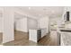 Bright kitchen features a center island, modern appliances, granite countertops, and hardwood floors at 1940 Van Allen Ct, Dacula, GA 30019