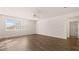 Spacious living room with wood-look floors, natural light, and a ceiling fan at 1940 Van Allen Ct, Dacula, GA 30019