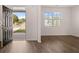 Open living room boasts lots of natural light and wood flooring at 1940 Van Allen Ct, Dacula, GA 30019
