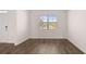 Bright living area with wood flooring and large window overlooking the front yard at 1940 Van Allen Ct, Dacula, GA 30019