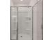 Close up of bathroom shower with sliding glass doors and built-in shelves at 1940 Van Allen Ct, Dacula, GA 30019