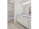 Bright bathroom with double vanity, large mirror, and shower with sliding glass door at 2261 Seatton Ct, Marietta, GA 30062