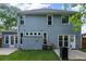 Rear exterior of home with windows, door to backyard, and grill on patio at 2261 Seatton Ct, Marietta, GA 30062