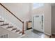 Welcoming home entrance with staircase, cabinet, tile flooring, and large window at 2261 Seatton Ct, Marietta, GA 30062