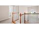 Upstairs hallway with wood and white railing overlooking the entry at 2261 Seatton Ct, Marietta, GA 30062