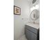 Stylish powder room with gray vanity, marble countertop, round mirror, and modern lighting at 2261 Seatton Ct, Marietta, GA 30062