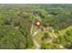 Aerial view showcasing the home's location amidst lush greenery and wooded surroundings at 6610 Major Dr, Cumming, GA 30040