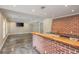Finished bar area with brick accent wall, live edge counter, and stainless sink at 6610 Major Dr, Cumming, GA 30040