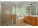 Light-filled bathroom with soaking tub and glass shower at 6610 Major Dr, Cumming, GA 30040