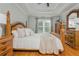 Bedroom featuring a wood frame bed, nightstands and bright windows at 6610 Major Dr, Cumming, GA 30040