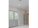 Bright bedroom featuring carpeted floors, French doors, and modern lighting at 6610 Major Dr, Cumming, GA 30040