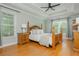 Bedroom featuring a wood frame bed with a ceiling fan and bright windows at 6610 Major Dr, Cumming, GA 30040