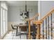 Formal dining room with modern chandelier, wainscoting, and hardwood floors at 6610 Major Dr, Cumming, GA 30040