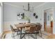 Elegant dining room featuring a wooden table, modern chandelier, and stylish decor at 6610 Major Dr, Cumming, GA 30040