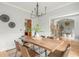 Inviting dining room with hardwood floors, modern light fixture and sightlines to office at 6610 Major Dr, Cumming, GA 30040